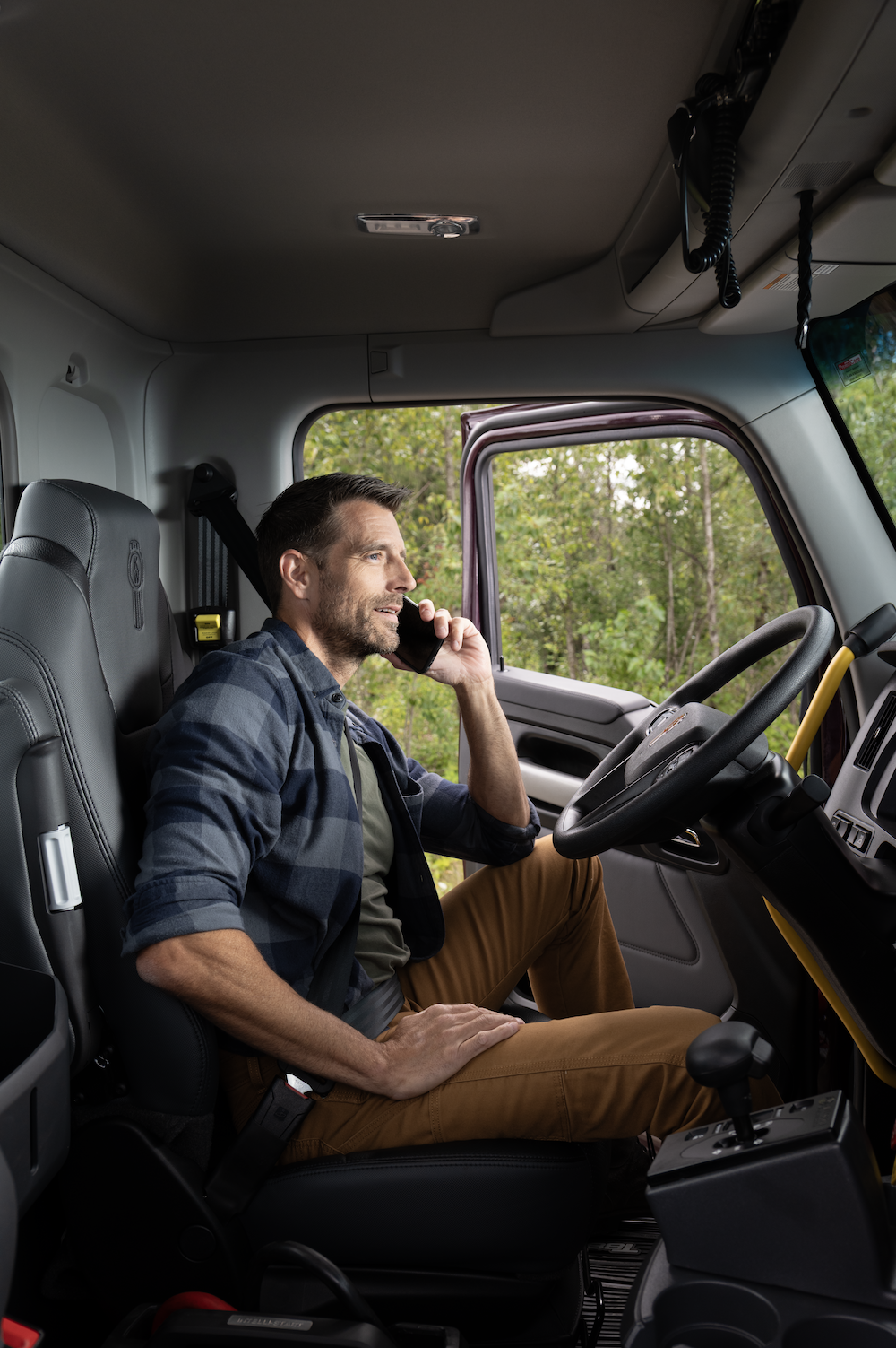 A Kenworth technician services a truck